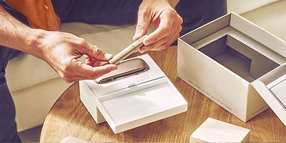 IQOS DUO on a table while two people are talking