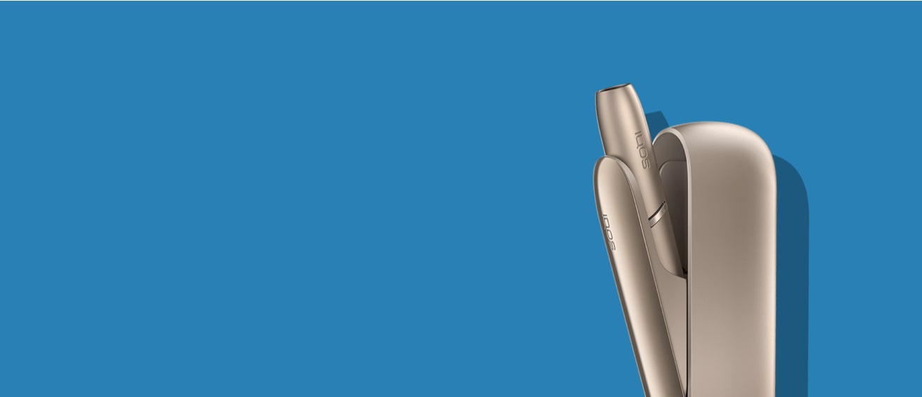 Brilliant gold IQOS 3 DUO holder in its charger.