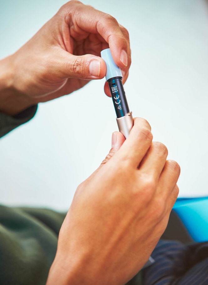 Man cleaning his IQOS holder 