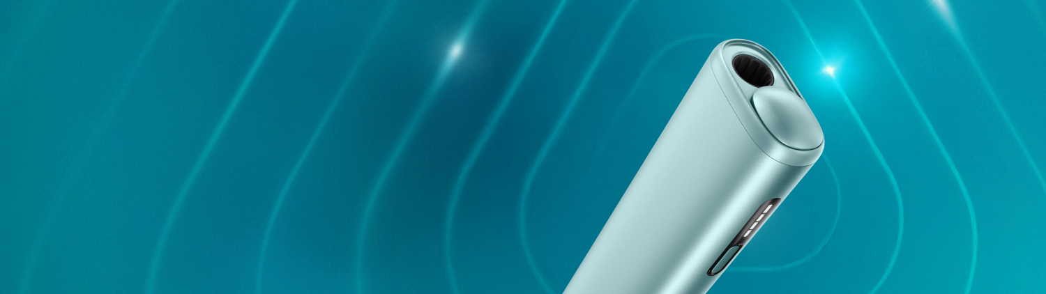 Garnet Red IQOS ILUMA i device and its charger on a dark turquoise background