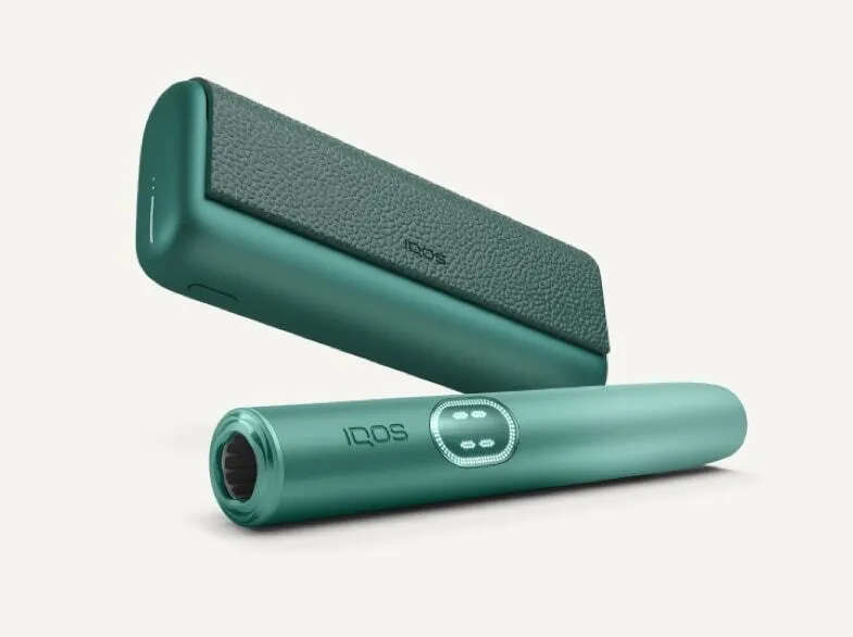 A jade green IQOS ILUMA PRIME device.