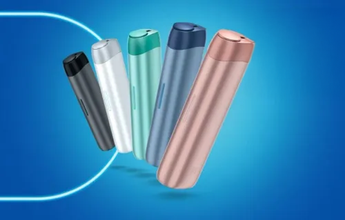 5 Lil SOLID Ez devices in pink, white, grey, teal and light blue positioned in a fan shape with a price on iqos.com of 29€. On the left side the copy is in white IQOS presents Lil SOLID Ez, Changing is easy, up to 25 consecutive uses