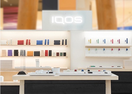 Brilliant gold IQOS 3 Duo holder and charger on a leather wallet